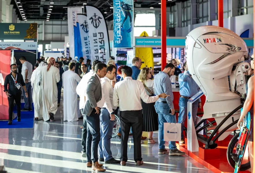 Visitors at an exhibition stand at ADNEC