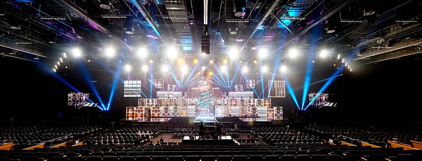 ADNEC ICC hall with a lit stage and audience seating