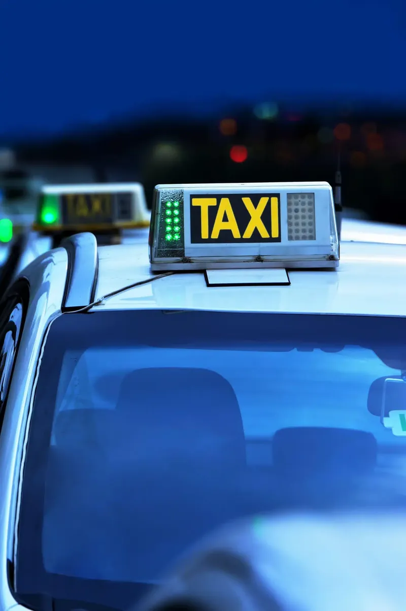 Taxi roof sign lit at dusk